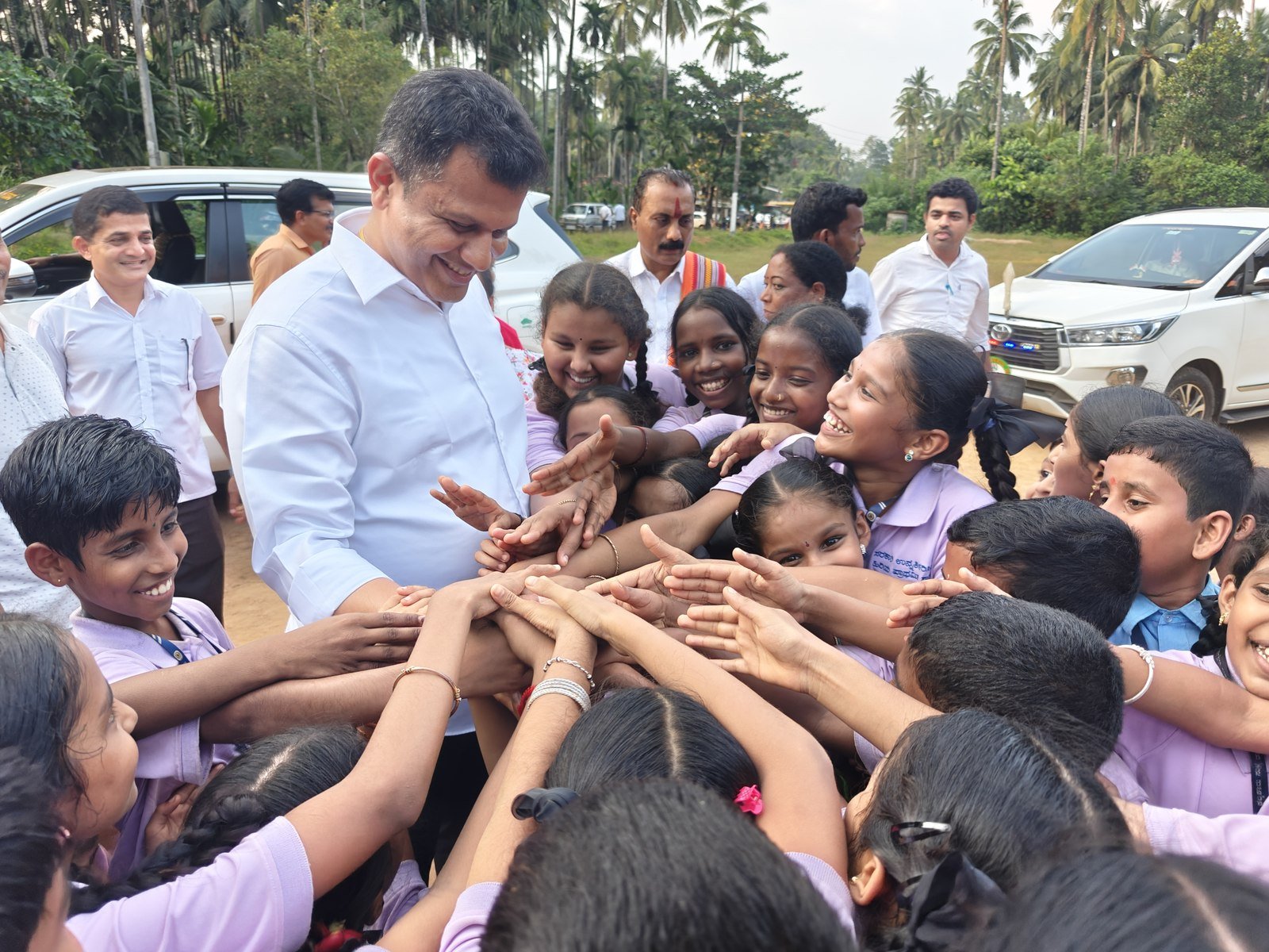 With schoolchildren, on the ground
